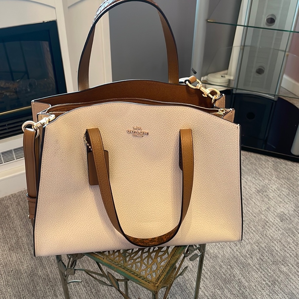 Coach shoulder bag it’s been use a few times but honestly still looks like new .